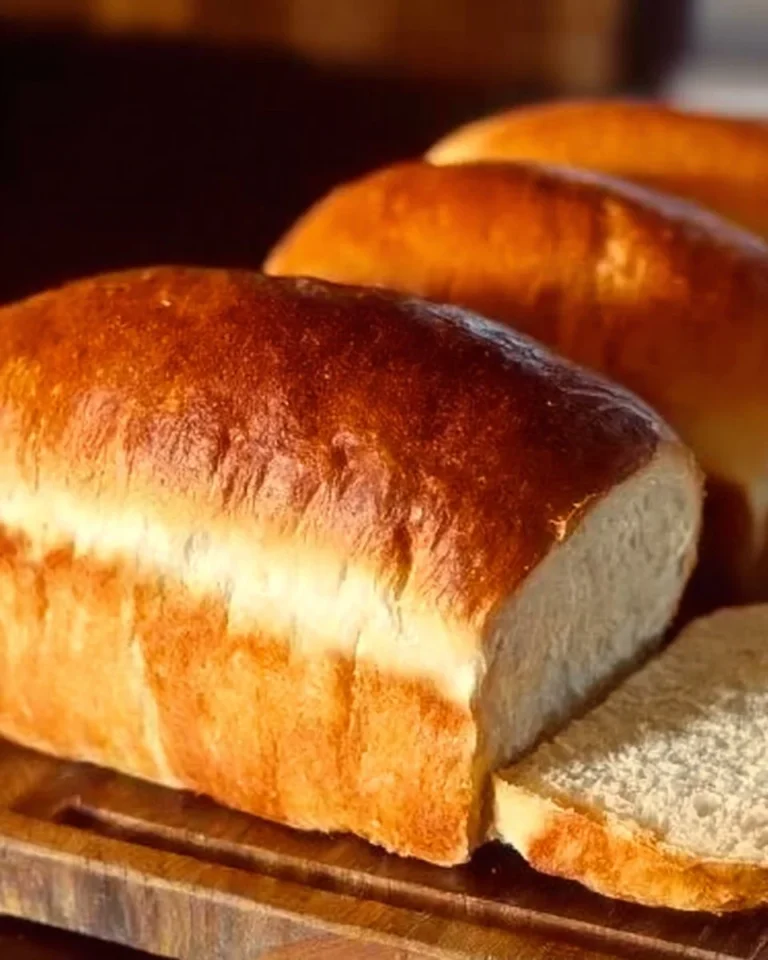 Freshly baked Amish white bread loaf on a wooden table