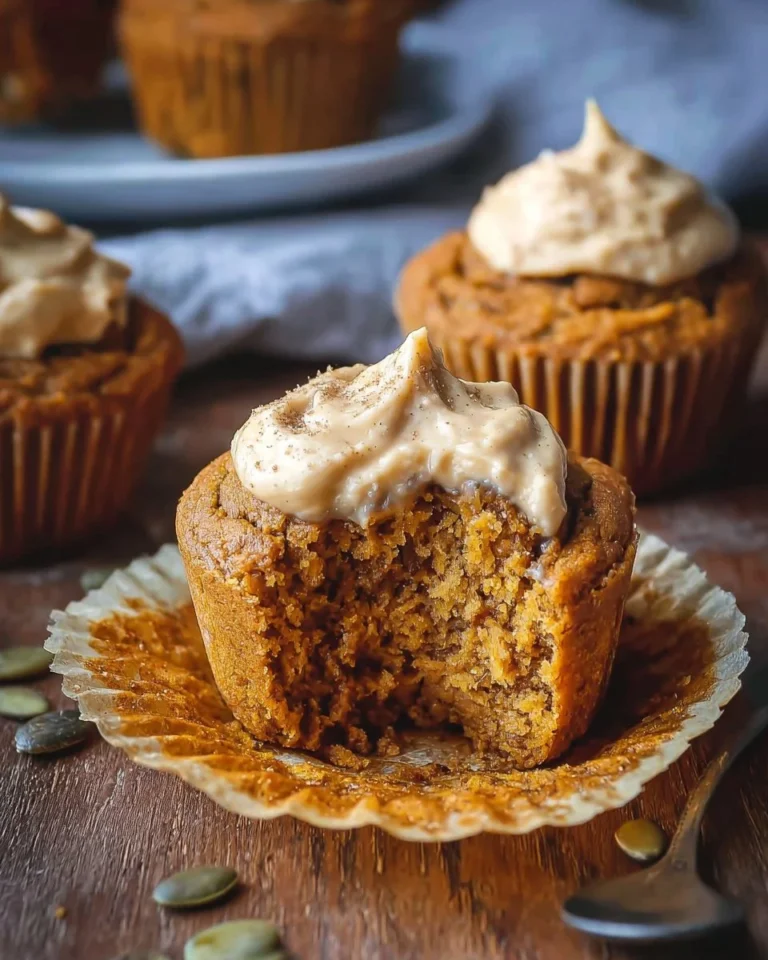 Gluten-free keto pumpkin muffins on a wooden table with autumn decorations