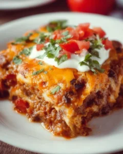 Delicious beef enchilada casserole with cheese and toppings, ready to serve.