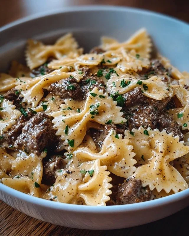 Creamy Parmesan garlic beef bowtie pasta served in a bowl