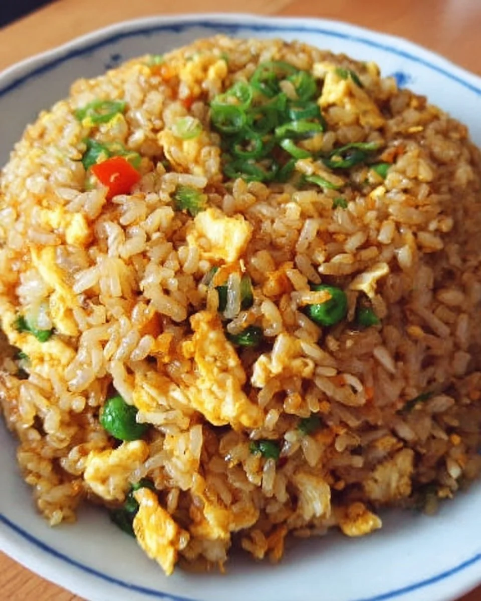 Delicious plate of easy homemade fried rice with vegetables and scrambled eggs