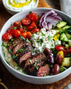 Mediterranean steak bowl with fresh vegetables and flavorful sauce