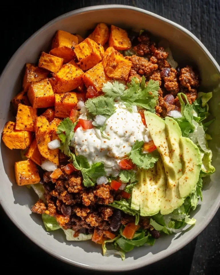 Colorful sweet potato taco bowl filled with fresh vegetables and toppings
