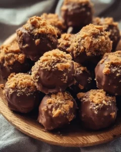 Delicious Butterfinger Bliss Balls on a wooden plate