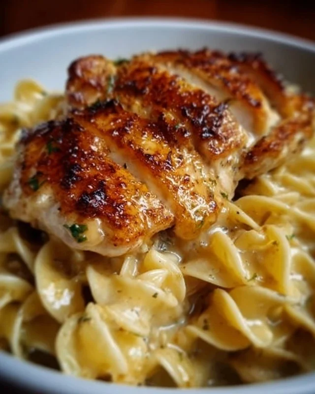 Plate of Chicken with Buttered Noodles garnished with parsley