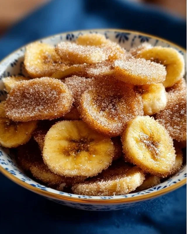 Cinnamon-sugar air fryer banana chips in a bowl, a delicious snack option.