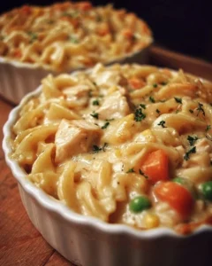 Classic chicken pot pie pasta topped with herbs and served in a bowl.