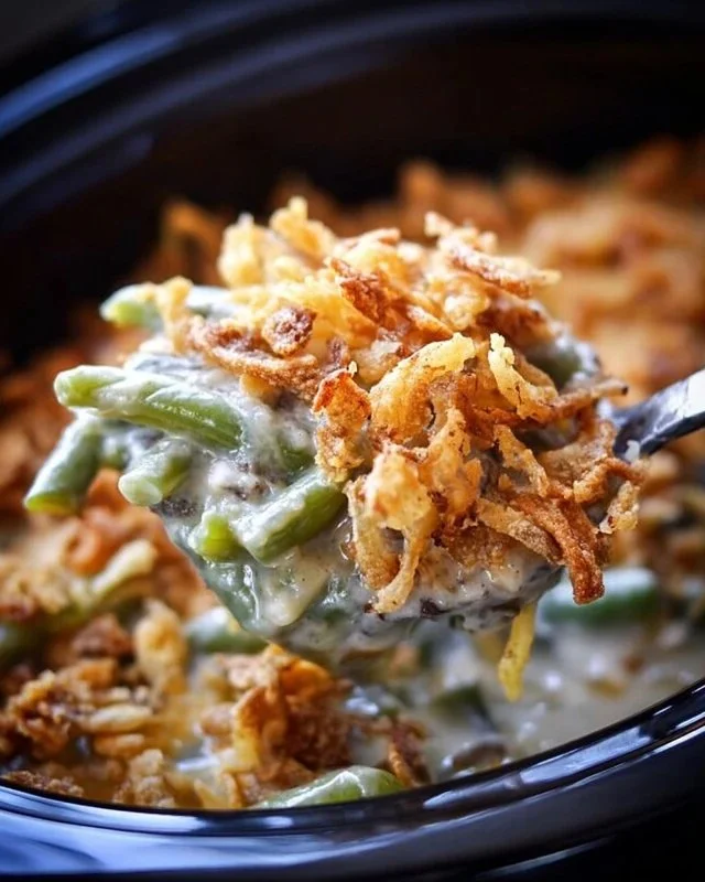 Delicious Crock Pot green bean casserole topped with crispy fried onions.
