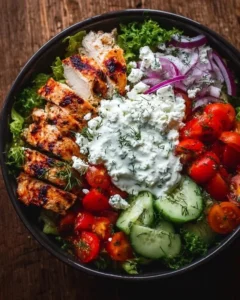 Delicious Greek Chicken Bowl with fresh vegetables and tzatziki sauce