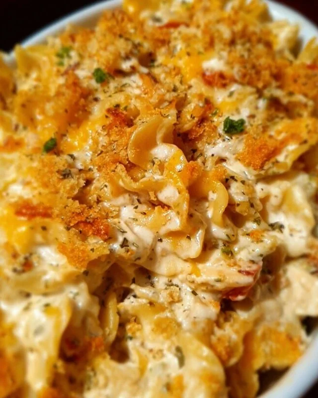 Delicious Million Dollar Chicken Casserole topped with cheese and herbs