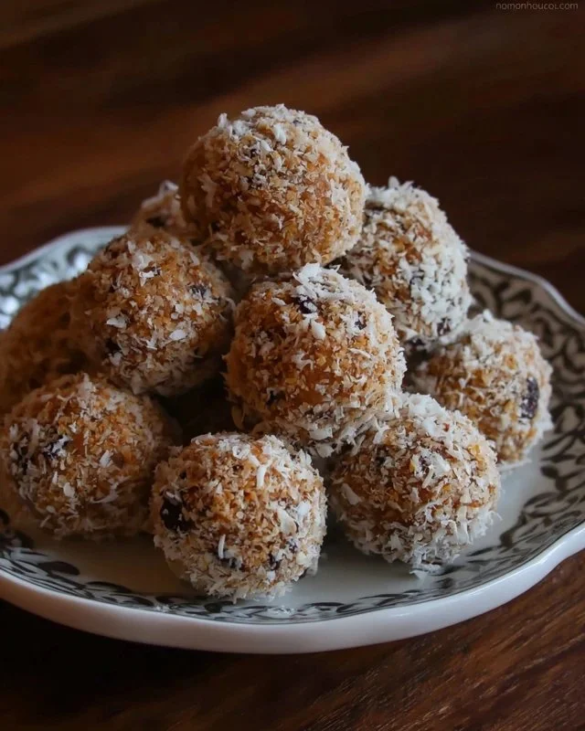 No-bake chocolate coconut graham balls stacked on a white plate