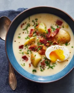 Homemade old-fashioned potato soup served in a bowl with fresh herbs