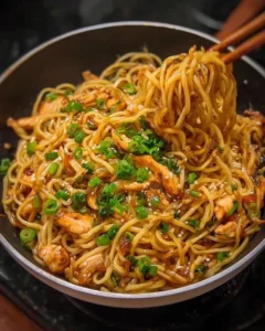 Delicious sticky garlic chicken noodles served in a bowl