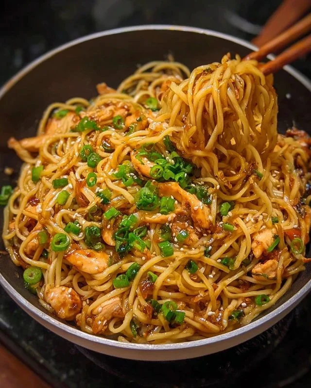 Delicious sticky garlic chicken noodles served in a bowl