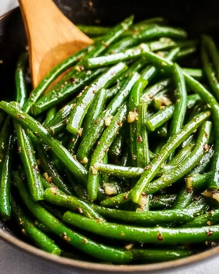 Sautéed green beans cooked in butter and garlic, served as a side dish.