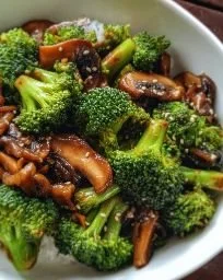 Vegan broccoli mushroom stir fry in a colorful bowl with fresh ingredients
