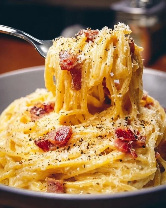 Delicious plate of authentic Carbonara pasta with creamy sauce and pancetta.