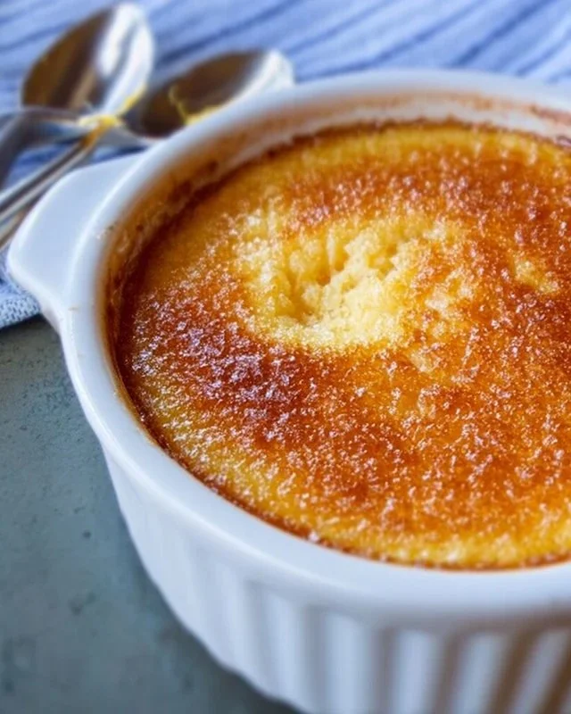 Deliciously baked lemon pudding dessert served in a glass dish