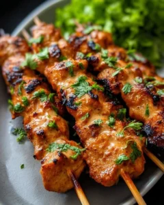 Delicious Bang Bang Chicken Skewers served on a platter with dipping sauce