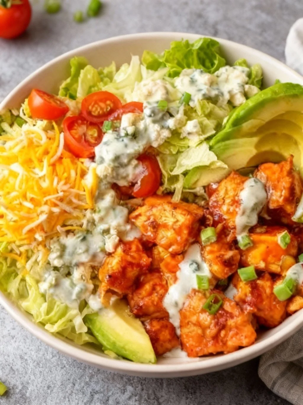 Delicious Buffalo Chicken Bowl topped with fresh ingredients and spicy sauce