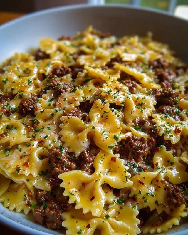 Cajun Cream Cheese Alfredo Bowties with Spiced Ground Beef dish plated on a table