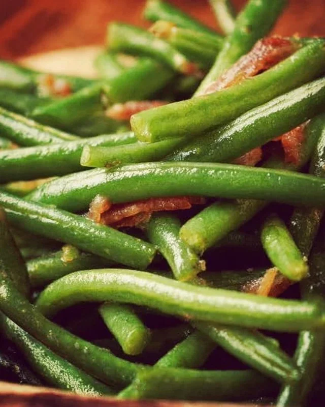 Plate of delicious crack green beans, garnished and ready to serve.