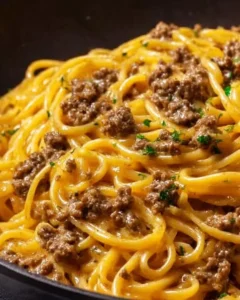 Creamy garlic butter pasta dish with ground beef and herbs