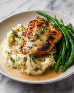 Creamy garlic parmesan chicken breast garnished with herbs