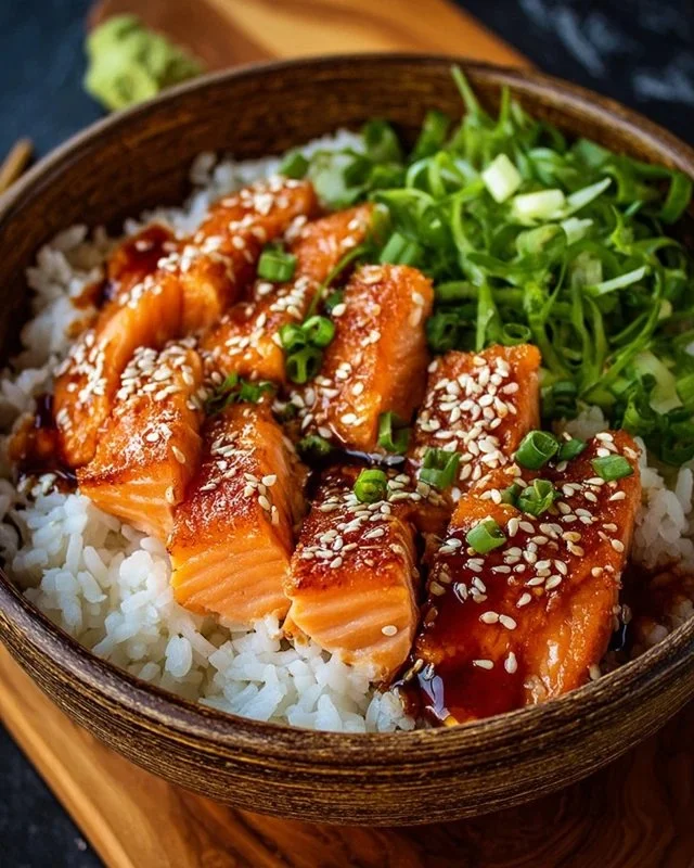Crispy Salmon served on a rice bowl with vibrant vegetables.