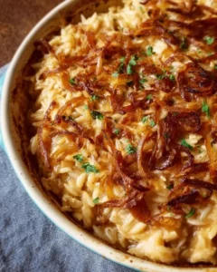 Delicious French Onion Chicken Orzo Casserole topped with melted cheese