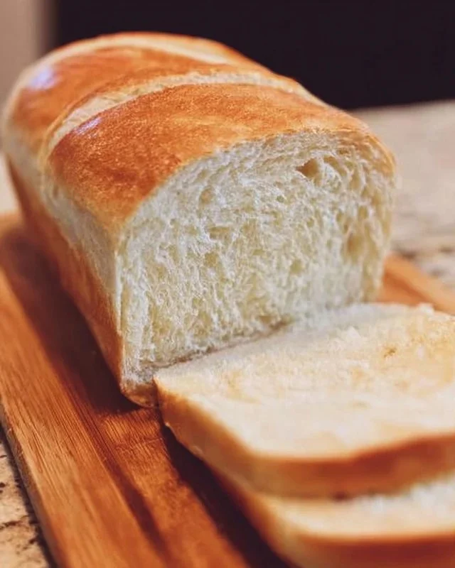 Freshly baked homemade bread loaves on a wooden table.