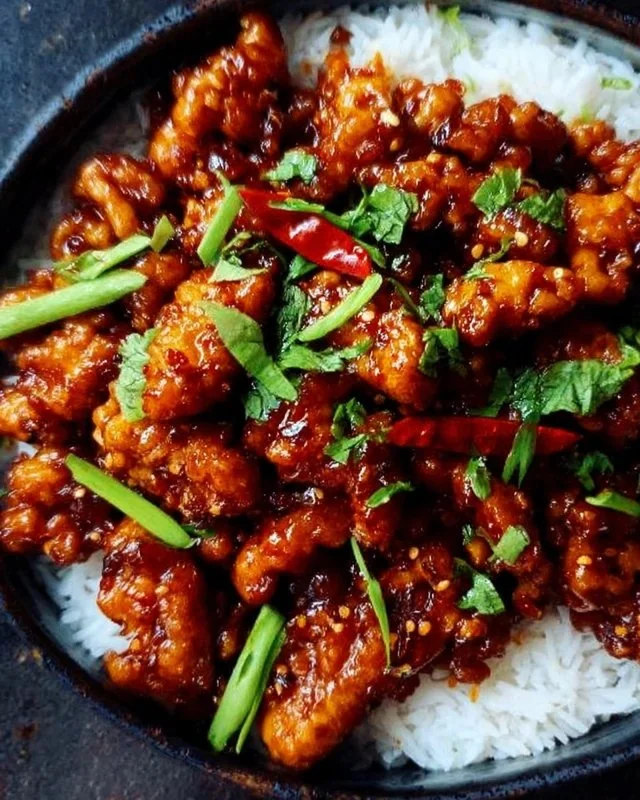 Plate of spicy Dragon Chicken garnished with vegetables