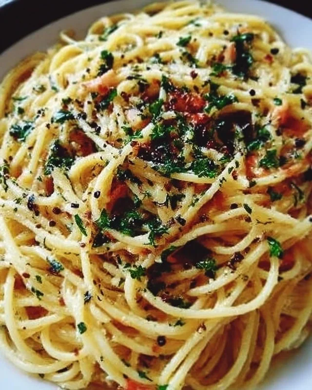 A plate of Midnight Pasta with fresh ingredients and herbs, ready to enjoy at night.