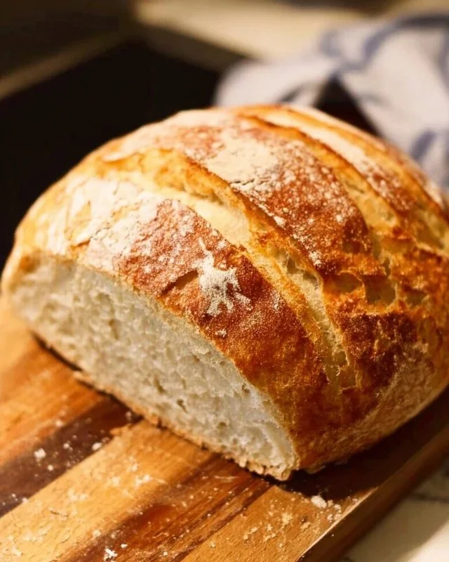 Freshly baked no knead bread loaf on a wooden table