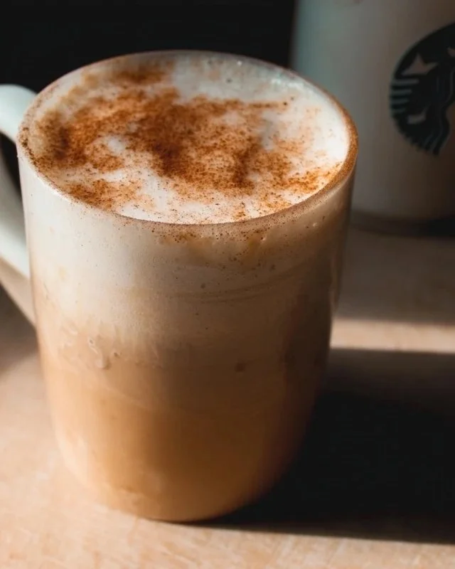 Starbucks Chai Tea Latte cup with spices and latte art on top