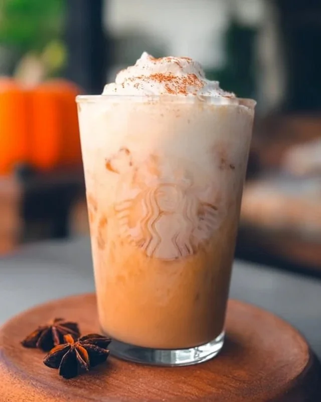 Iced Pumpkin Cream Chai Tea Latte from Starbucks topped with pumpkin cream.