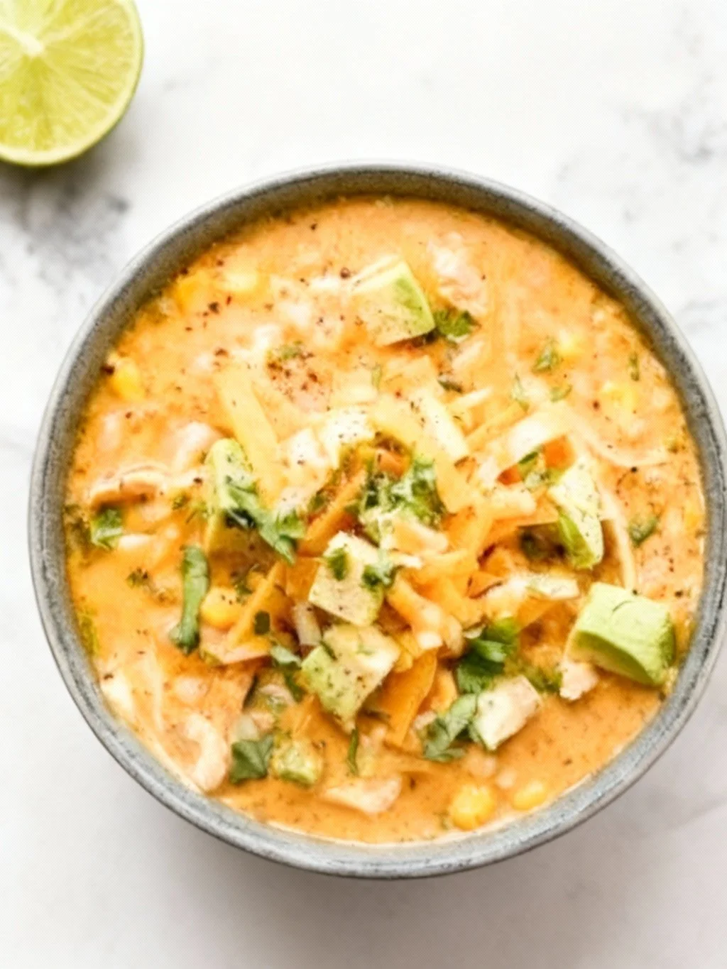 Delicious bowl of white chicken chili topped with cilantro and served with tortilla chips.
