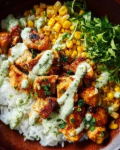 Delicious street corn chicken rice bowl with vibrant toppings and colors