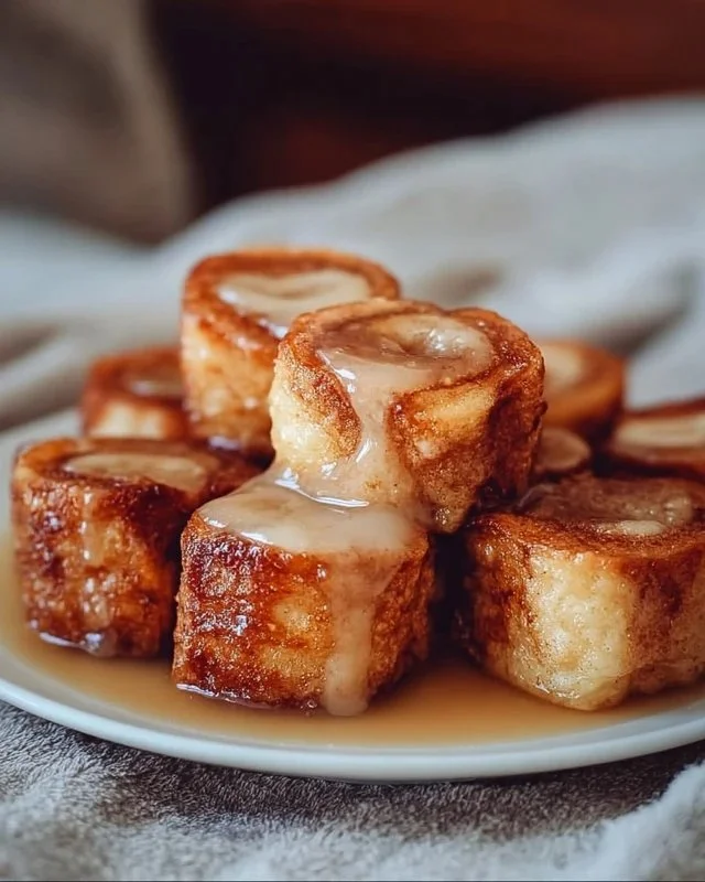 Cinnamon Roll French Toast Bites served on a plate with syrup