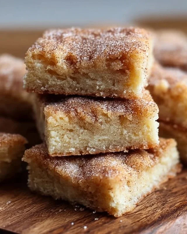 Freshly baked Cinnamon Sugar Blondies topped with a sprinkle of cinnamon sugar.