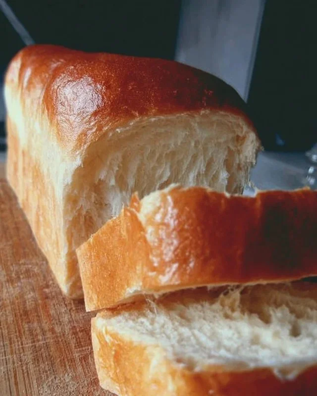 Freshly baked easy milk bread loaf cooling on a wire rack