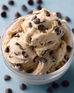 Bowl of Greek yogurt cookie dough with chocolate chips and a spoon.