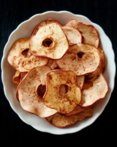 Homemade apple cinnamon chips on a wooden table