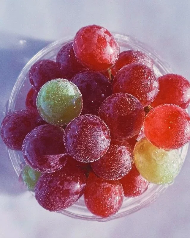 Colorful Kool-Aid Grapes arranged on a plate as a fun snack.