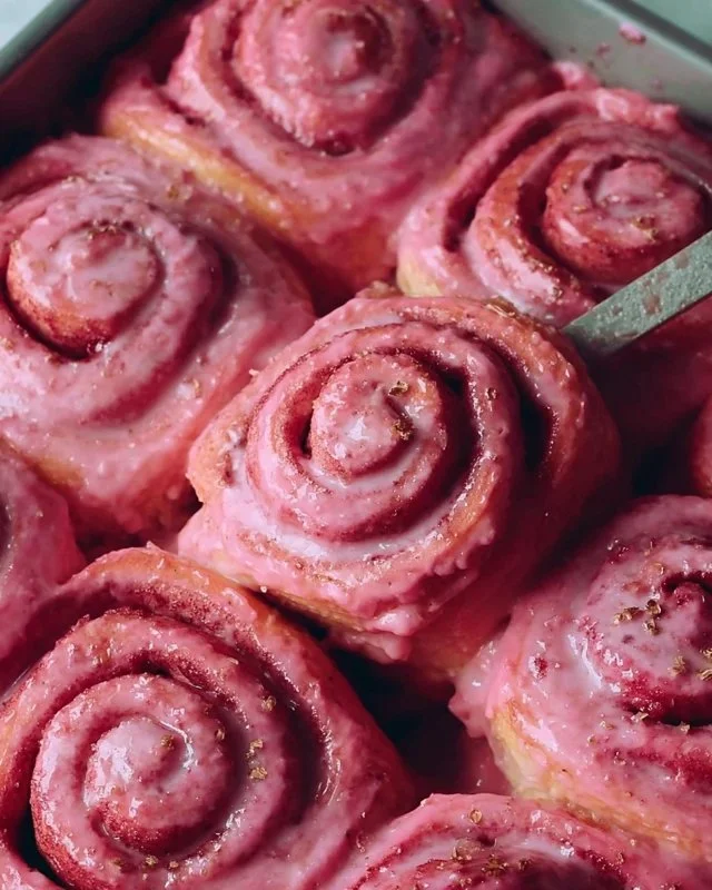 Delicious pink velvet cinnamon rolls topped with cream cheese frosting