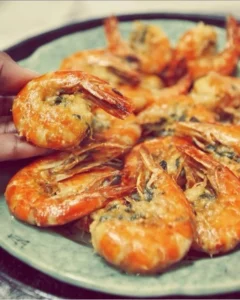 Delicious stuffed shrimp ready to serve, garnished with herbs and spices.