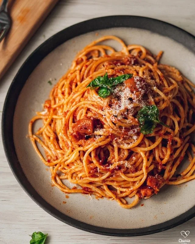 A delicious plate of Bear Spaghetti garnished with fresh herbs and cheese