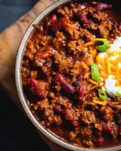A bowl of the best ever chili recipe with ground beef, beans, and spices.