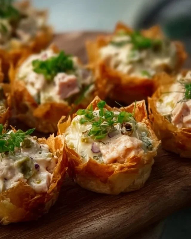 A platter of assorted cold appetizers including dips, vegetables, and cheeses.