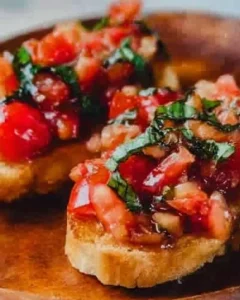 Plate of authentic Italian bruschetta topped with tomatoes and basil